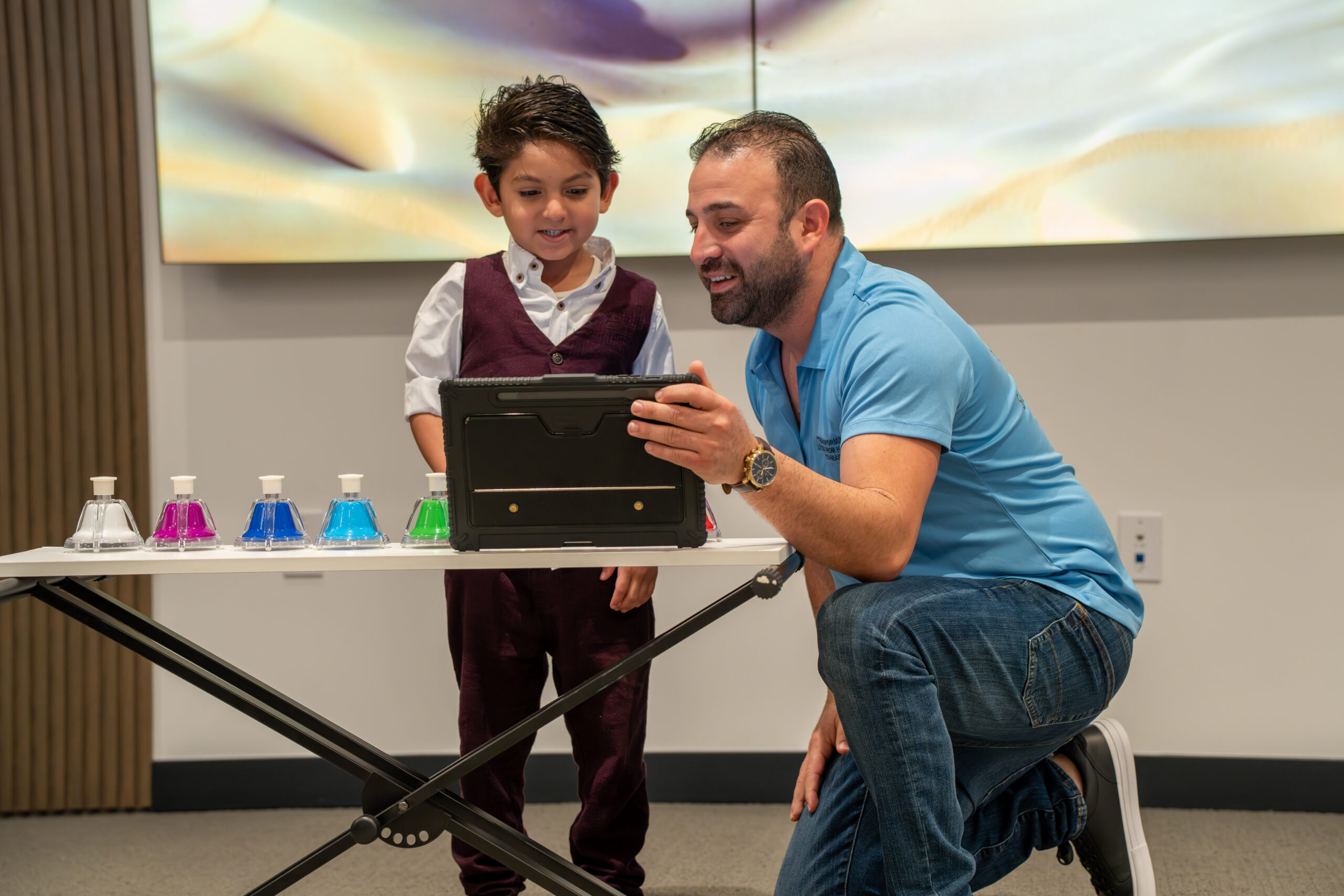 A child playing a musical instrument during a Music & Movement session at Miami Supreme