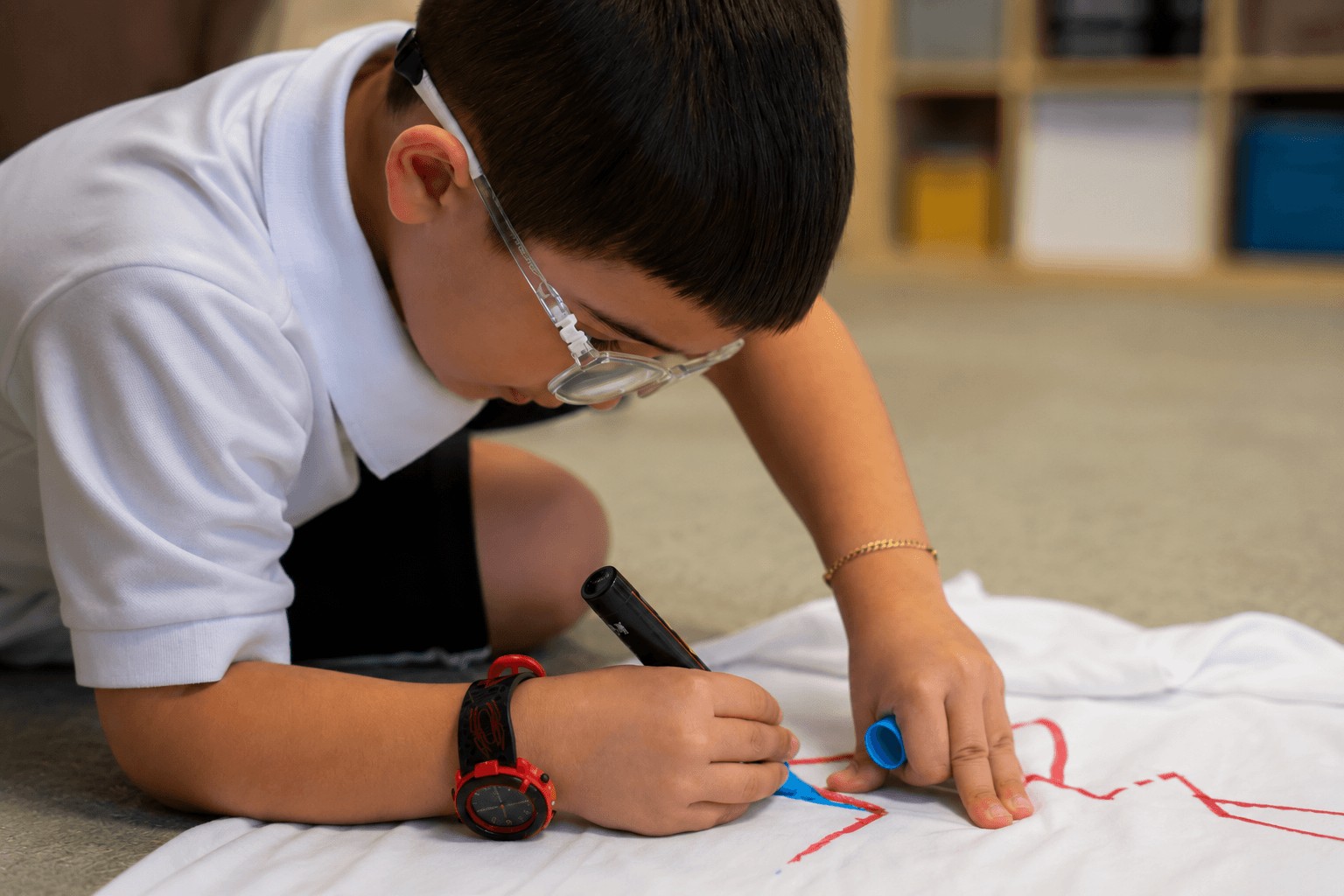 Child drawing with a marker during an art session at Miami Supreme